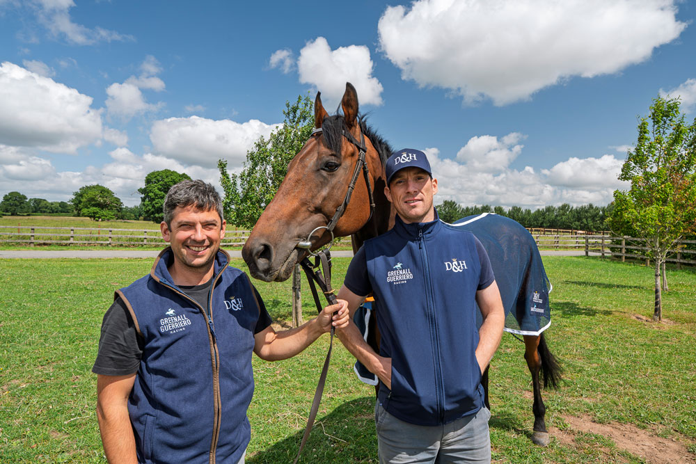 two men with a horse in-between